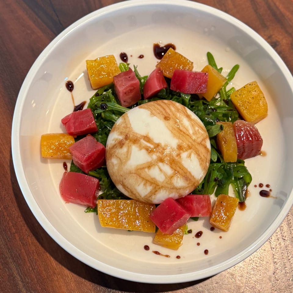 Burrata cheese with arugula, red and golden beets, drizzled with balsamic glaze at Crush'd Wine Bar Kitchen.